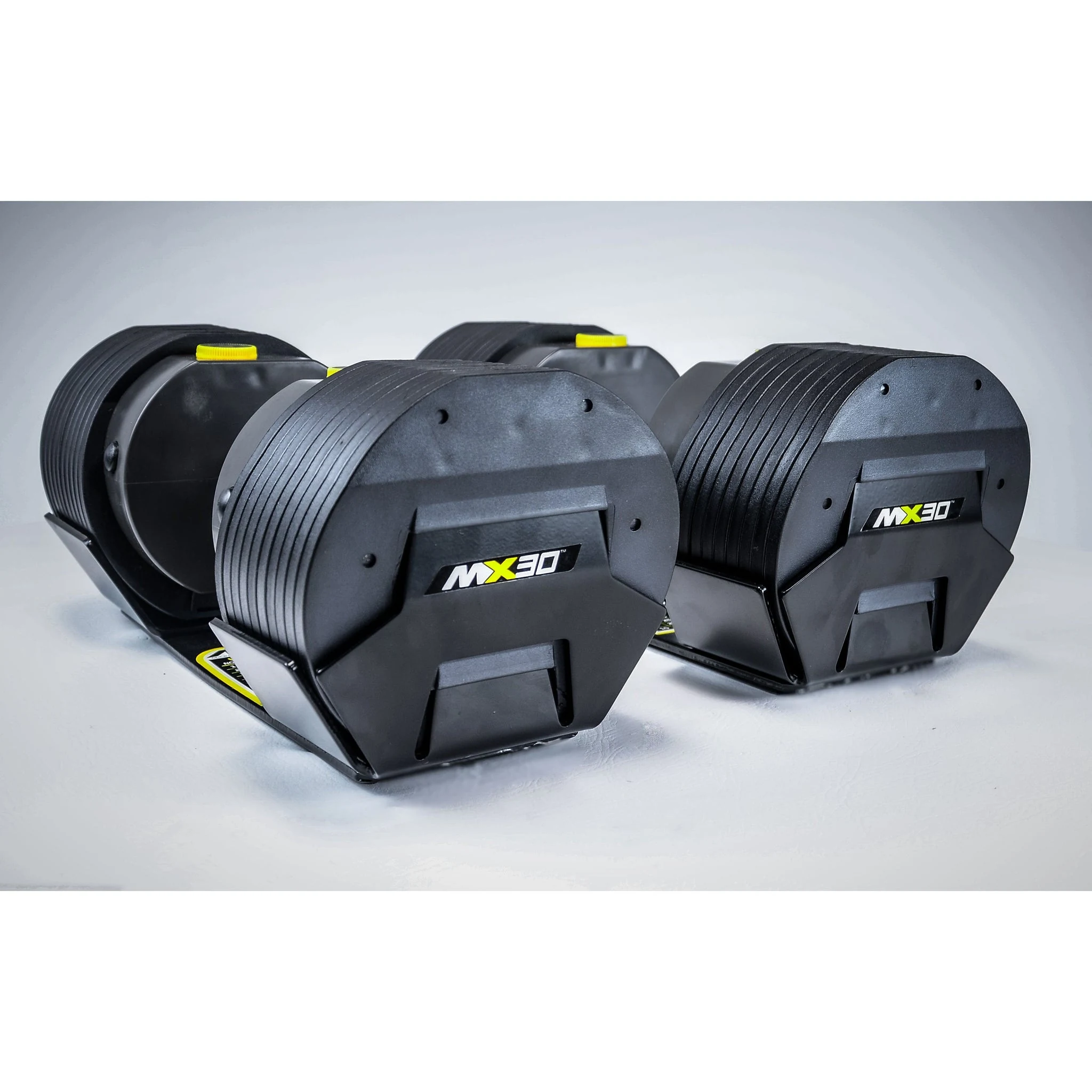 Two MX30-marked adjustable dumbbell handsets shown seated in separate cradles